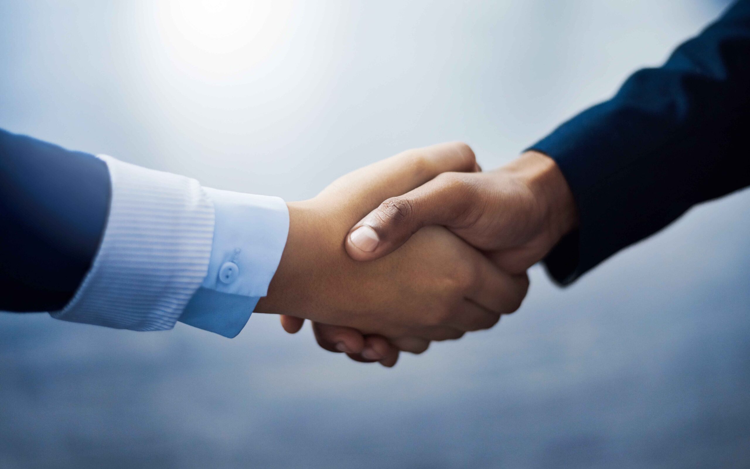closeup-shot-of-two-unrecognizable-businesspeople-2023-11-27-05-29-13-utc (1) upclose of two hands shaking to showcase the partnership between sequence and its partner companies